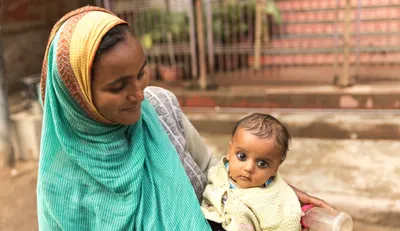 A woman holding her baby